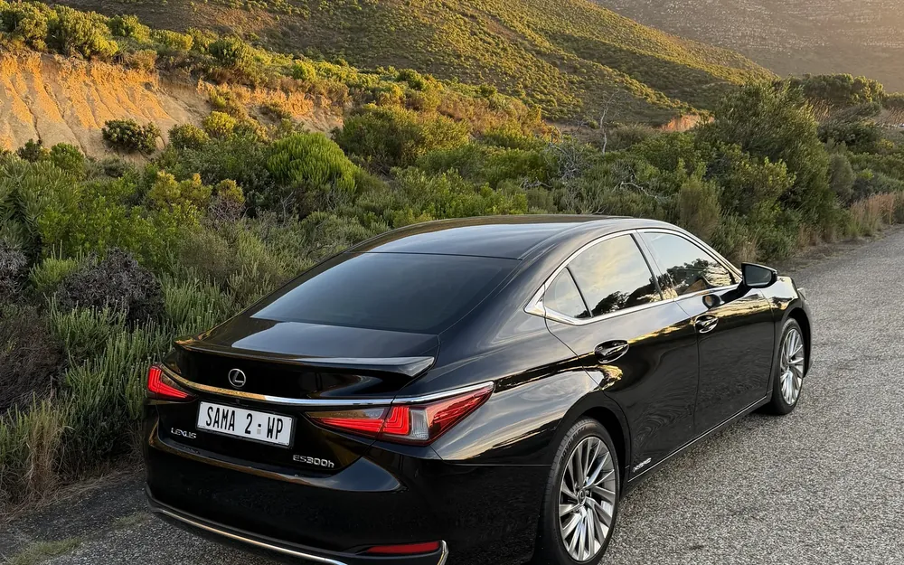 Rear view of SAMA 2, a black Lexus ES 300h, below the mountains in evening light